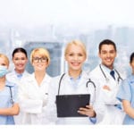 smiling female doctors and nurses with stethoscope