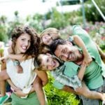 family having fun in a greenhouse