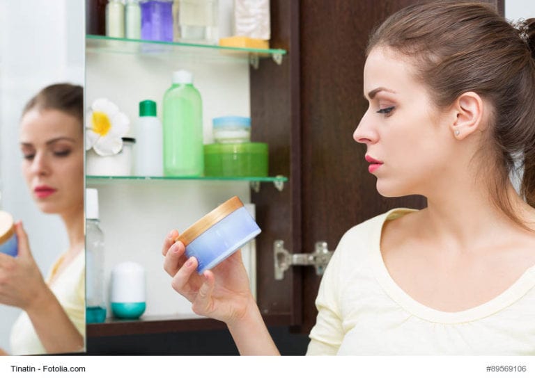 Woman Looking At Makeup Image