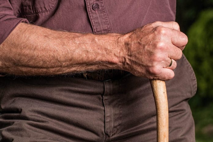 Man Holding Cane Image