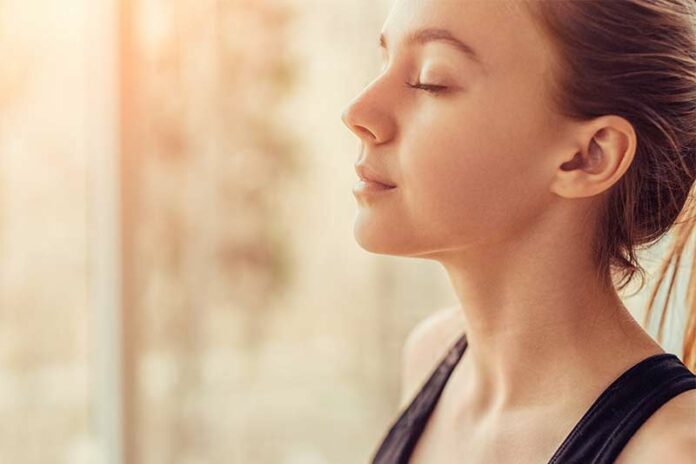 Woman meditating and calmly releasing anxiety
