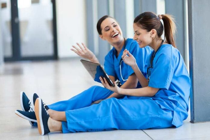 Two female nurses in blue scrubs