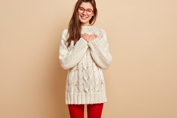 Girl in glasses and sweater feeling grateful