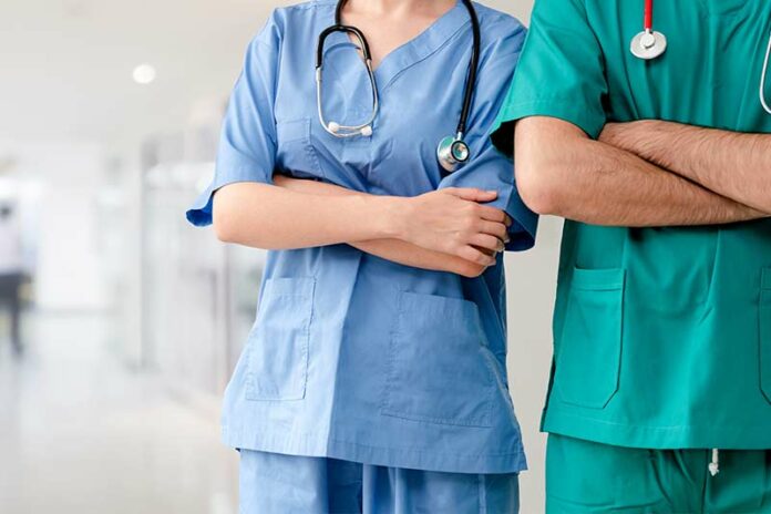Male and female nurse standing with reassurance as to why they are nurses