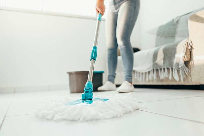 Nurse mopping the floor during spring cleaning