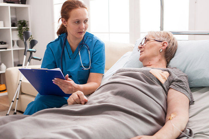 Female nurse talking with older patient