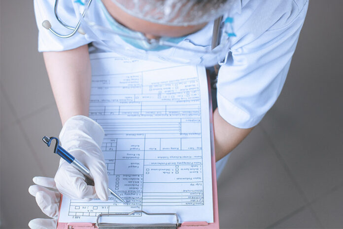 Nurse writing down on chart